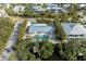Aerial view showcasing a single-Gathering home with a pool in a waterfront community at 115 Los Cedros Dr, Anna Maria, FL 34216