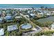 Aerial view of a single-Gathering home with a private pool and lush landscaping, close to the beach at 115 Los Cedros Dr, Anna Maria, FL 34216