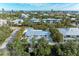 Aerial view of a single-Gathering home with pool, situated in a residential neighborhood near the ocean at 115 Los Cedros Dr, Anna Maria, FL 34216
