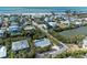 Aerial view of a single-Gathering home with a private pool and lush landscaping, close to the beach at 115 Los Cedros Dr, Anna Maria, FL 34216