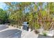 Outdoor grilling area with lush tropical landscaping at 115 Los Cedros Dr, Anna Maria, FL 34216