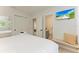Comfortable bedroom with a queen bed and en-suite bathroom at 115 Los Cedros Dr, Anna Maria, FL 34216