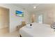 Main bedroom with a queen bed, TV, and access to a bathroom at 115 Los Cedros Dr, Anna Maria, FL 34216