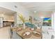 Bright dining area with farmhouse table and view of living room at 115 Los Cedros Dr, Anna Maria, FL 34216