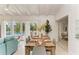 Elegant dining area with a rustic wood table and seating for six at 115 Los Cedros Dr, Anna Maria, FL 34216