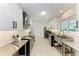 Clean kitchen with stainless steel appliances and herringbone tile at 115 Los Cedros Dr, Anna Maria, FL 34216
