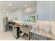 Modern kitchen features stainless steel appliances and a herringbone tile backsplash at 115 Los Cedros Dr, Anna Maria, FL 34216
