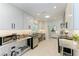 Modern kitchen with stainless steel appliances and white cabinets at 115 Los Cedros Dr, Anna Maria, FL 34216