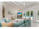 Open living space showcasing a teal couch and pool view at 115 Los Cedros Dr, Anna Maria, FL 34216