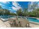 Enjoy alfresco dining adjacent to the refreshing pool at 115 Los Cedros Dr, Anna Maria, FL 34216