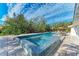 Inviting pool and spa with patio furniture, offering a relaxing outdoor oasis at 115 Los Cedros Dr, Anna Maria, FL 34216