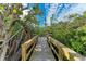 Serene wooden deck overlooking lush greenery at 115 Los Cedros Dr, Anna Maria, FL 34216