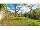 Landscaped backyard with pond view and lush vegetation at 123 Pinehurst Dr, Bradenton, FL 34210