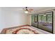 Bright bedroom with hardwood floors, ceiling fan and access to a screened porch at 123 Pinehurst Dr, Bradenton, FL 34210