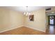 Simple dining room with chandelier and view into the kitchen at 123 Pinehurst Dr, Bradenton, FL 34210