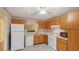 Efficient kitchen featuring wood cabinets and white appliances at 123 Pinehurst Dr, Bradenton, FL 34210