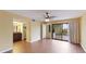 Main bedroom with hardwood floors, access to a patio, and an ensuite bathroom at 123 Pinehurst Dr, Bradenton, FL 34210