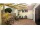 Relaxing patio area, shaded by a pergola, featuring brick pavers at 123 Pinehurst Dr, Bradenton, FL 34210