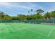Well-maintained community tennis court with benches at 123 Pinehurst Dr, Bradenton, FL 34210