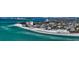 A picturesque aerial view of a beachfront neighborhood with pristine white sand beaches at 126/128 Avenida Veneccia, Sarasota, FL 34242