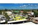 Aerial view of Siesta Village featuring colorful buildings and lush greenery under a bright sky at 126/128 Avenida Veneccia, Sarasota, FL 34242