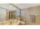 Bathroom featuring a marble countertop vanity and toilet, with neutral-striped wallpaper at 126/128 Avenida Veneccia, Sarasota, FL 34242