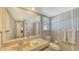 The bathroom features blue and white striped wallpaper, a toilet, a sink, and a shower at 126/128 Avenida Veneccia, Sarasota, FL 34242