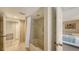 Bathroom with a shower and tub combo, tiled walls, and access to the bedroom at 126/128 Avenida Veneccia, Sarasota, FL 34242