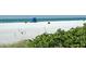 Expansive beach view featuring a lifeguard station and calm ocean waters at 126/128 Avenida Veneccia, Sarasota, FL 34242