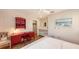 Bedroom with a red desk, white bedding, a ceiling fan, and natural light streaming through a window at 126/128 Avenida Veneccia, Sarasota, FL 34242