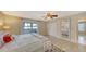 Bright bedroom features tile floors, a ceiling fan, closet, and sliding glass doors to the balcony at 126/128 Avenida Veneccia, Sarasota, FL 34242