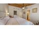 Bedroom with wood ceiling includes a walk-in closet and ensuite bathroom at 126/128 Avenida Veneccia, Sarasota, FL 34242