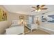 Bright bedroom featuring two twin beds and a ceiling fan with an ensuite bathroom at 126/128 Avenida Veneccia, Sarasota, FL 34242