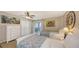 Bright bedroom featuring two twin beds, a ceiling fan, and sliding glass doors to a balcony at 126/128 Avenida Veneccia, Sarasota, FL 34242