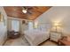 Cozy bedroom features a wood-paneled ceiling, plush rug, dresser and ample natural light at 126/128 Avenida Veneccia, Sarasota, FL 34242