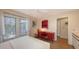 Bedroom with a ceiling fan, white bedding, a red desk, and natural light streaming through a bright window at 126/128 Avenida Veneccia, Sarasota, FL 34242