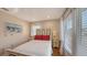 Bright bedroom features a ceiling fan, white bedding, and matching side tables with lamps at 126/128 Avenida Veneccia, Sarasota, FL 34242
