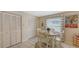 Cozy dining area with seating for four, with large closets and a window at 126/128 Avenida Veneccia, Sarasota, FL 34242
