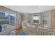 Open dining area with deck access, white curtains, terracotta floors, and plenty of natural light at 126/128 Avenida Veneccia, Sarasota, FL 34242