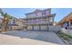 Exterior of a charming elevated beach house with three-car garage and ample parking at 126/128 Avenida Veneccia, Sarasota, FL 34242