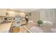Bright kitchen featuring white cabinetry, tile flooring, and a dining area with seating for four at 126/128 Avenida Veneccia, Sarasota, FL 34242