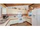 Well-equipped kitchen with white cabinets, modern appliances, and functional layout at 126/128 Avenida Veneccia, Sarasota, FL 34242