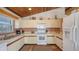 Bright kitchen featuring white appliances, wood accents, and plenty of counter space at 126/128 Avenida Veneccia, Sarasota, FL 34242