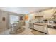 Bright kitchen with stainless steel appliances, white cabinets, and an eat-in breakfast nook at 126/128 Avenida Veneccia, Sarasota, FL 34242