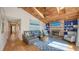 Spacious living room with a wooden ceiling, brick fireplace, and stylish decor at 126/128 Avenida Veneccia, Sarasota, FL 34242