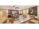 Open-concept living room with ceiling fan, tile floors, elegant decor and large dining table at 126/128 Avenida Veneccia, Sarasota, FL 34242