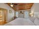 Bright main bedroom features a wooden ceiling, ceiling fan, patterned chair, and is adjacent to the main bathroom at 126/128 Avenida Veneccia, Sarasota, FL 34242