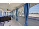 Enclosed patio with comfortable seating and blue curtains offers great views at 126/128 Avenida Veneccia, Sarasota, FL 34242