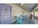 Charming porch with outdoor seating, decorative cushions, and a view of the neighborhood at 126/128 Avenida Veneccia, Sarasota, FL 34242