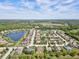 Community overview with lake, houses, and lush landscape at 13207 49Th E Ln, Parrish, FL 34219